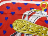 a picture of a red and white scarf with blue hearts on it