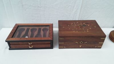 two wooden boxes are sitting on a table with a wooden lid