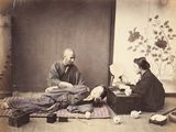 a man and woman sitting on the floor in a room