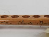 a wooden stick with writing on it with a ribbon around it