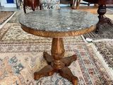 a table with a marble top on a rug in a room