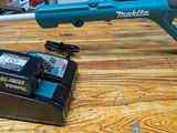 a cordless blower and two batteries on a table