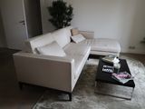 a white couch and a coffee table in a living room