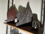 a shelf that has a couple of sculptures on top of it