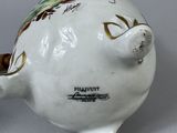 a white ceramic pig that is sitting on top of a table