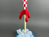 a toy rocket that is sitting on top of a blue plate
