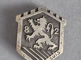 an image of a silver badge with a lion on it