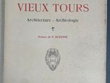 un vieux livre posé sur une table à côté d'un mur bleu