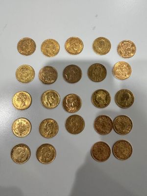 a close up of a pile of gold coins sitting on top of a table
