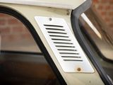 a close up of a car door with a window vent