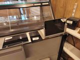 a display case with laptops and other electronic devices on it