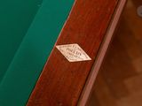 a pool table with a green cloth and a sticker on it