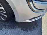 a close up of a car ' s bumper with a dent on it