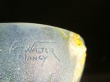 a close up of a blue bowl with writing on it