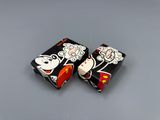 pair of mickey and minnie mouse dice game pieces sitting on a table