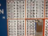 many pairs of glasses on display in a store