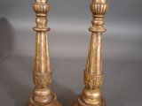 pair of antique brass candlesticks on a grey background