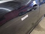 a black car with a sticker on the side of it