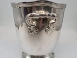 an antique silver plated wine cooler with two handles on a stand