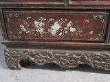 a wooden chest with a floral design on it
