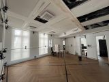 an image of a large empty room with wood floors