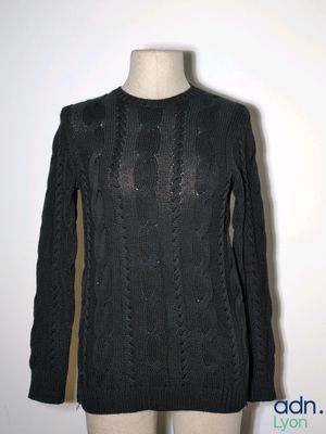 the sweater is black and has long sleeves and a round neck