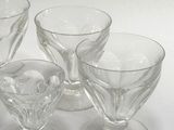 three wine glasses sitting on a table with a white background
