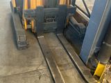 a fork lift truck parked in a large warehouse