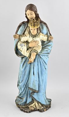 a statue of a woman holding a baby in her arms