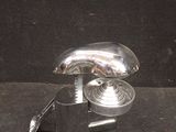 an image of a metal object on a black surface
