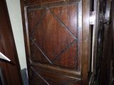 a wooden door that is open in a room