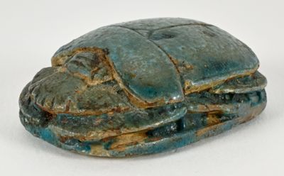 an image of a blue and green stone statue of a bug