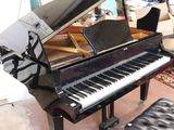 a piano and a stool in a living room