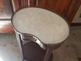 a small table with a marble top in a room
