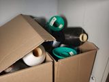 many rolls of tape in a box on a shelf