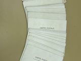 a stack of white envelopes sitting on top of a table