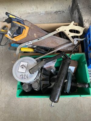 many different tools in a box on the floor