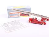 a close up of a toy fire truck with a box in the background