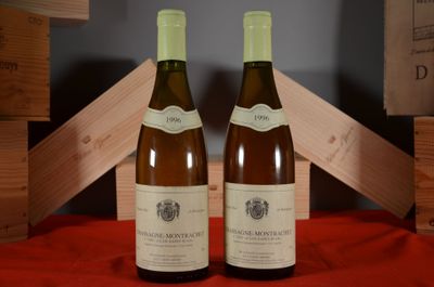 two bottles of wine sitting on a red table cloth