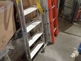 a ladder that is leaning against a wall in a warehouse