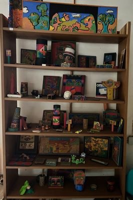 a book shelf with a lot of toys on top of it