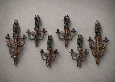 four antique wall sconces mounted on a wall in a room