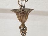 a silver vase with a bird on top of it