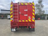 a red fire truck that is parked in a lot