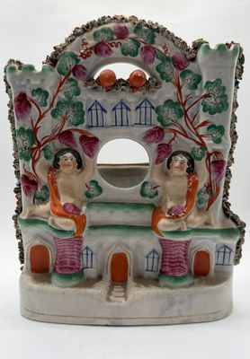 two figurines that are sitting on a table