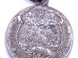 an image of a silver medal with a picture of a woman ' s face on it