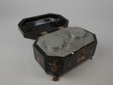 a black and gold box with two cups in it