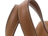 the back of a brown purse with white stitching on it