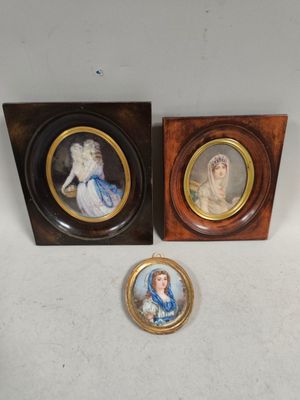 two framed pictures of a lady and a lady in a blue dress