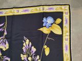 an image of a purple and yellow scarf with blue flowers on it